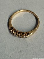Top view of gold ring showing four white stones