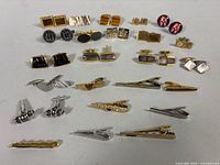 Full lot view showing all cufflinks and tie clips