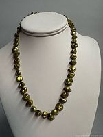 Full view of baroque freshwater pearl necklace on display form