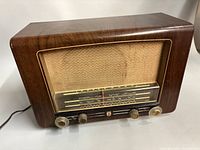 Front view of Philips Model 725 radio showing dial, grille, knobs, power cord