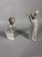 Both figurines side by side to show full forms and relative sizes