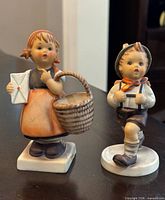 Front view of both figurines showing overall appearance