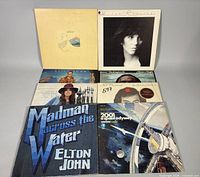 Group shot of all eight record sleeves laid out for overview