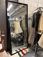Front view of full-length black-framed mirror