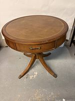 Top and partial leg view showing leather insert and wood finish