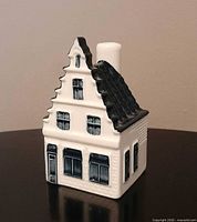 Front view of KLM Delft Blue house No. 73 showing stepped gable and painted windows