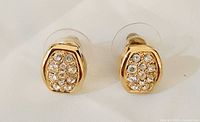 Front view of both Swarovski gold-tone crystal stud earrings