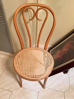 Full view of chair showing bentwood frame and cane seat