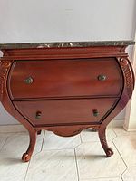 Front view showing overall shape, finish, hardware, legs