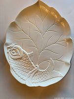 Full view of leaf-shaped porcelain platter with fish relief
