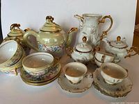 Grouped view of both porcelain tea services and accessories