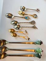 All 10 spoons laid out showing size and decorative finials