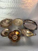 Group shot of six silver-plated serveware pieces