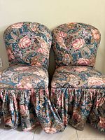 Front view of both floral paisley skirted side chairs