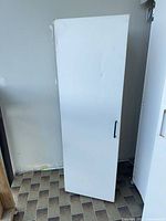 Door panel of smaller cabinet