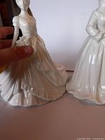 Pair of off-white porcelain Victorian lady figurines front view