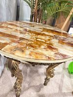 Top view showing veined onyx surface and gilt legs