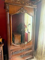 Full view of armoire showing mirrored doors and drawers