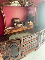 Front view showing dresser, mirror, glass top, drawers, cabinets