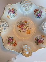 Top view showing floral pattern, pierced rim, gold trim
