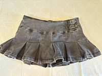 Front view of pleated denim skort