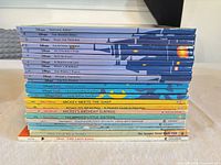 Stack of 23 Disney children’s hardcover books showing spines and titles