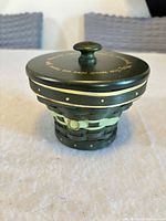 Closed basket showing exterior color, weave pattern, lid and knob