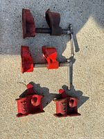 Full lot showing two screw clamp bodies and four swivel pipe saddles