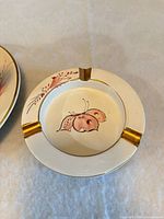 Small ashtray with pink butterfly and gold rests