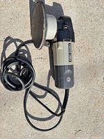 Full view of Porter-Cable orbital sander with coiled cord and sanding pad
