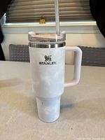 Side view of Stanley white marble 40 oz tumbler with handle and straw