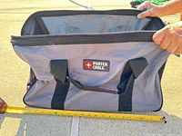 Exterior of grey Porter-Cable tool bag with tape measure showing height