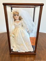 Full view of bridal doll in display case