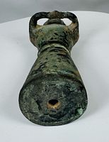underside of pottery figure showing hollow kiln vent and surface patina