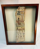 Coffin fragment mounted in glazed frame front view