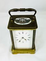 Front view showing enamel dial and brass case