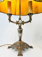 Lamp base, twin candle sockets, push-button switch, cord visible