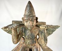 Front view showing full Garuda figure with wings and raised palms