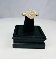 Front view of ring on stand showing engraved bezel