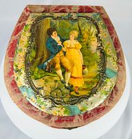 Lid showing courting scene within ornate frame and floral/bird decoration