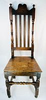 Full front view showing high back, crest rail, slats, turned legs and stretcher
