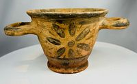 Skyphos side view showing floral rosette and both handles