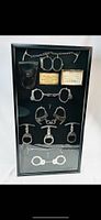Full view of framed restraint collection showing all items mounted