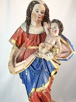 Front view showing Madonna in red-blue robes holding Child with gilt orb, colors and facial details visible
