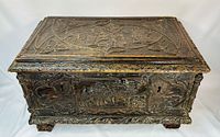Overall view of carved cassone showing lid and front carvings