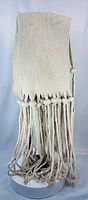 Full view of woven sash showing upper band and long tassels