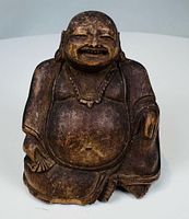 Front view of carved wooden Hotei figure