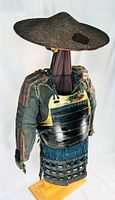 Three-quarter left view showing jingasa, cuirass, kote sleeves, kusazuri on stand