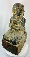 front view of kneeling parcel-gilt wooden devotee on base
