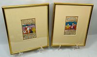 Both framed manuscript leaves on stands, front view